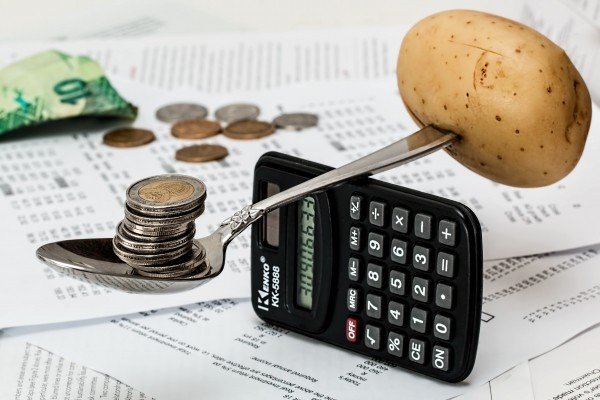 coins-on-spoon-with-potato-and-calculator